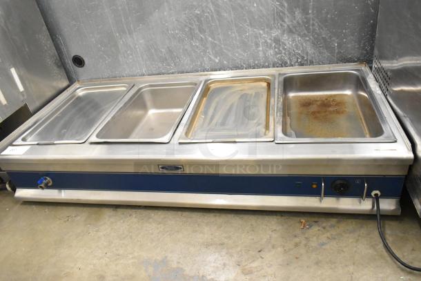 Stainless steel 4-well electric steam table, commercial countertop, untested, previously hardwired, visible wear.