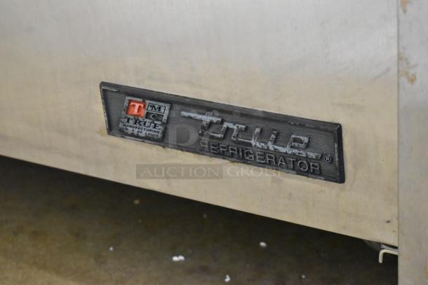 True TSSU-72-30M-B-ST stainless steel prep table, missing lid, on commercial casters. Label reads “True Refrigerators.”