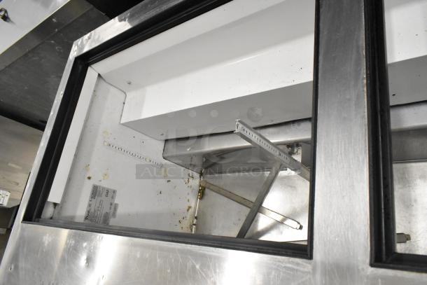 True TSSU-72-30M-B-ST stainless steel sandwich prep table missing lid, on commercial casters. Visible wear, 115 volts, 1 phase.