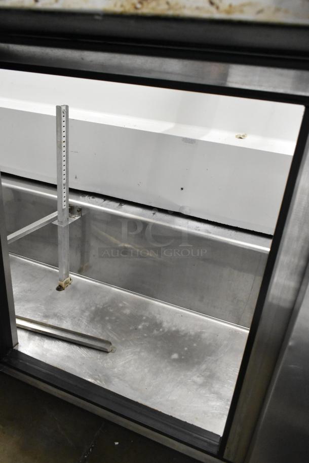 True TSSU-72-30M-B-ST stainless steel prep table, missing lid, on casters. Features bain marie setup, 115V, 1 phase.