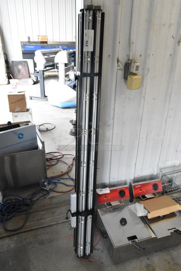 Alt text: Stack of 45 tube lights bundled together, leaning against a wall. Each unit in good condition with a label reading "Qty 45".