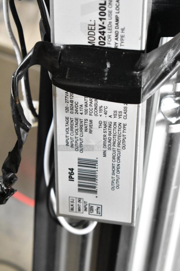 Close-up of tube light label showing model 024V-100L, input voltage 120-277VAC, output 24VDC, IP64 rating.