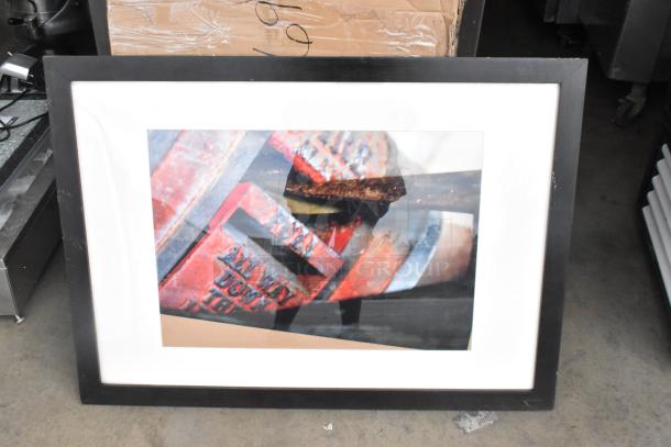 Framed photograph with a black frame, featuring abstract red and gray subject, emphasized by lines and texture.