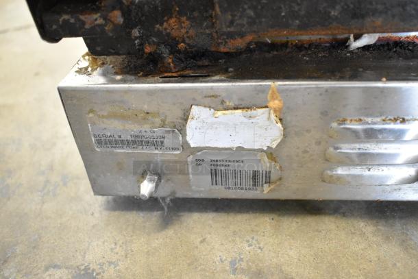 Cecilware stainless steel commercial double panini press with visible wear and rust, serial number label partially intact.