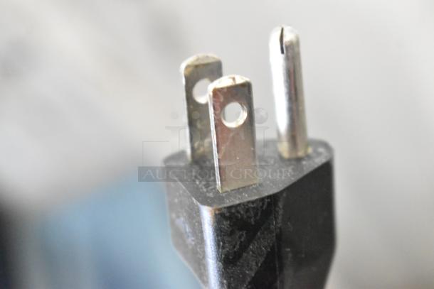 Close-up of Bunn VPR coffee machine's 120V plug, highlighting the prongs for commercial power supply connection.