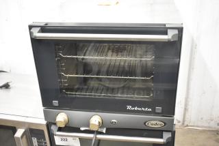 2016 Cadco Unox Roberta XAF003 stainless steel convection oven. Electric, 120V, 1 phase. Visible dials and Cadco label.