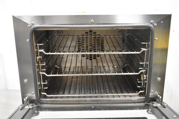 2016 Cadco Unox Roberta XAF003 stainless steel convection oven. Features 3 wire racks, electric-powered, 120 volts.
