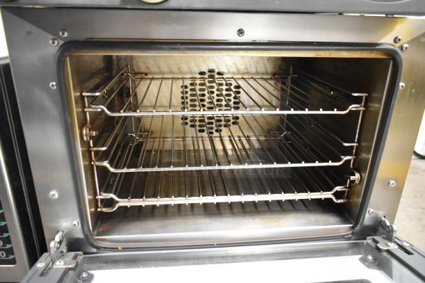 2016 Cadco Unox XAF003 stainless steel convection oven, 120 volts, with multiple racks, clean interior.