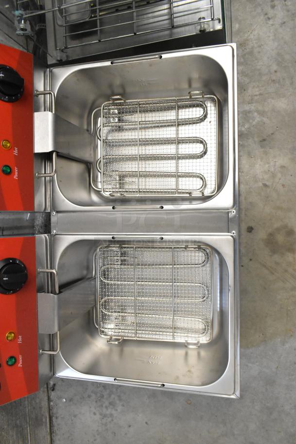 Brand new 2024 Avantco 177F102 stainless steel 20 lb. dual tank electric fryer with two metal baskets and lids.
