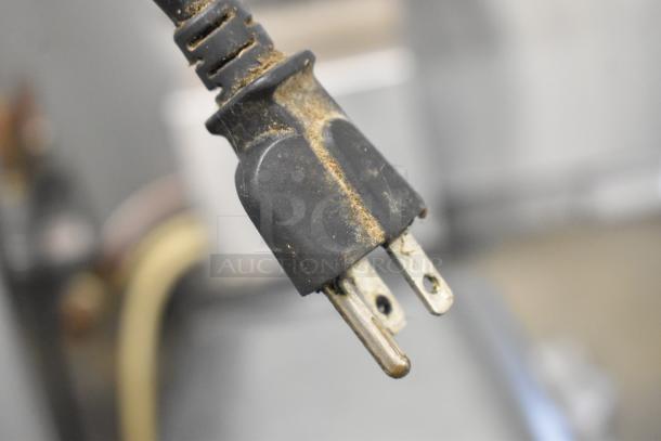Close-up of a used electrical plug for an Avantco MX30 commercial dough mixer, showing some wear on the prongs.