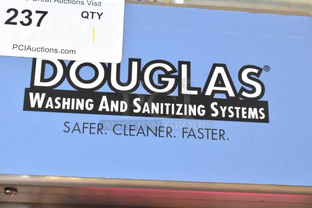 Douglas Stainless Steel Commercial Front Load Pot and Pan Washer. Features include high capacity and efficient cleaning. Visible label reads "Douglas Washing and Sanitizing Systems."