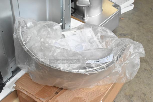 Metal commercial mixing bowl guard wrapped in plastic, resting on cardboard. Condition appears new with no visible damage.