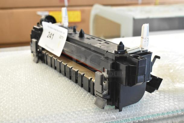 Black printer cartridge with visible gear and springs, labeled with auction tag "241". Appears in good condition.