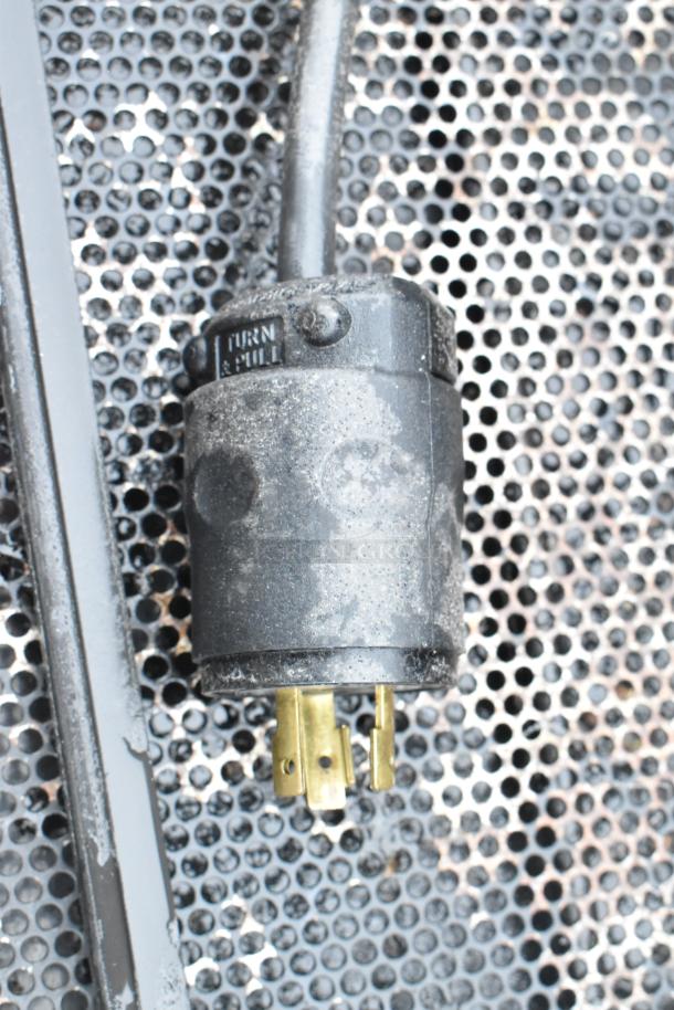 Close-up of a Killion PFW-74-43-48-V-N-MOBILE commercial merchandiser plug. Visible markings: "TURN & PULL."
