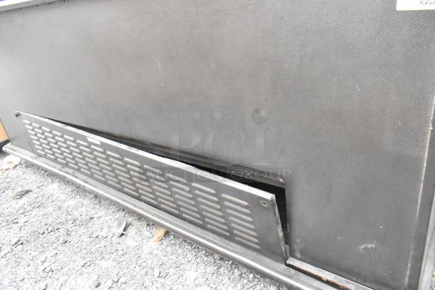 Metal commercial open grab-n-go merchandiser in fair condition, 208/230 volts, 1 phase. Visible vent panel dislodged.