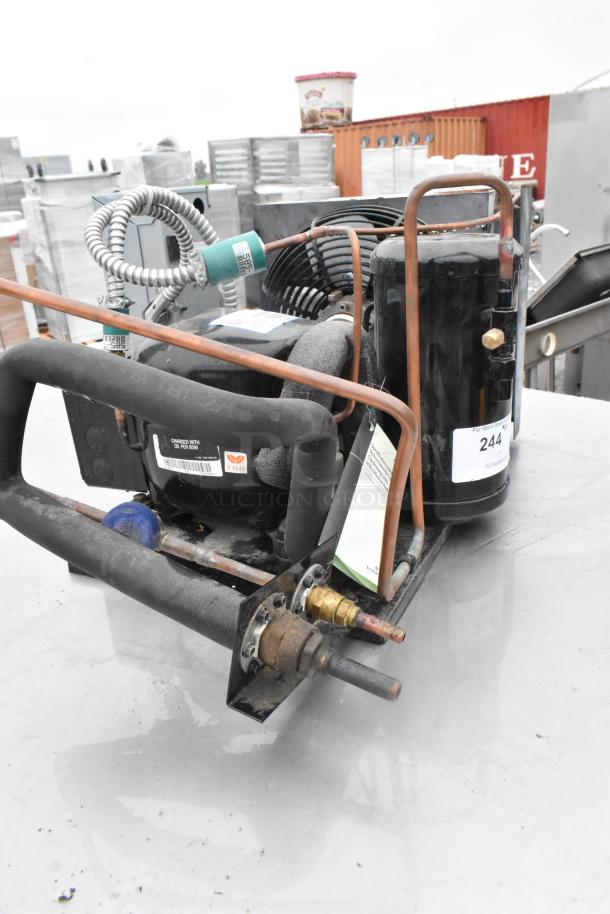 Copeland M4FHCA036-IAA-045 compressor, 115/208-230V, 1 phase, with visible tags indicating model and specs. Used condition.