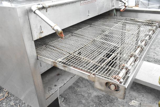 Blodgett MT3855G-G stainless steel conveyor oven with commercial casters, natural gas powered, 150,000 BTU, visible wear.