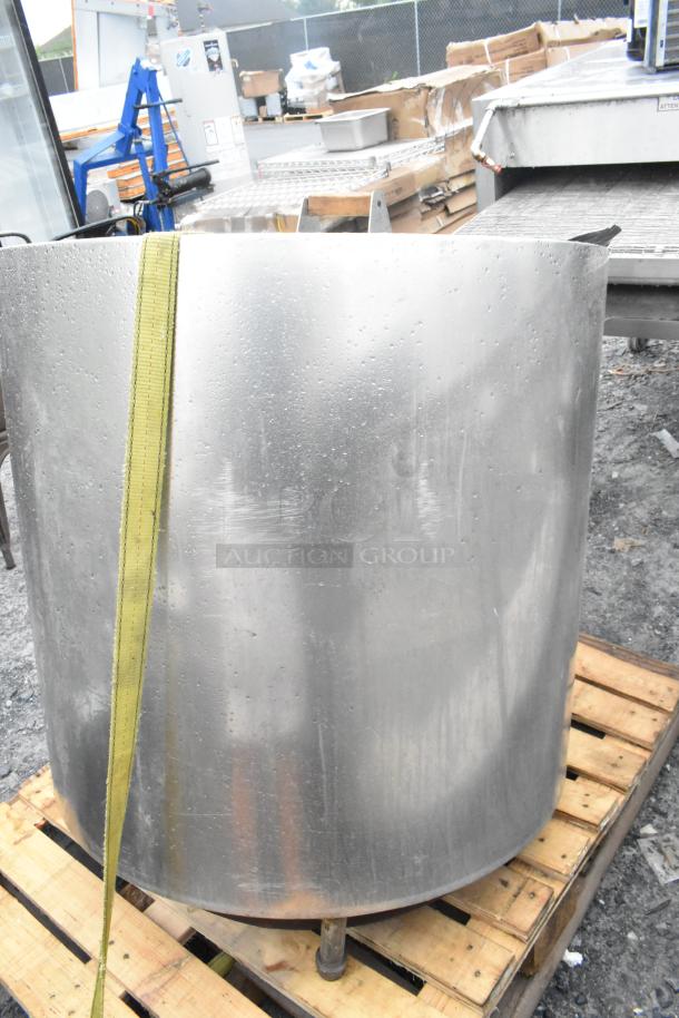 Stainless steel bagel kettle on a wooden pallet, showing some wear with watermarks; no visible labels or markings.