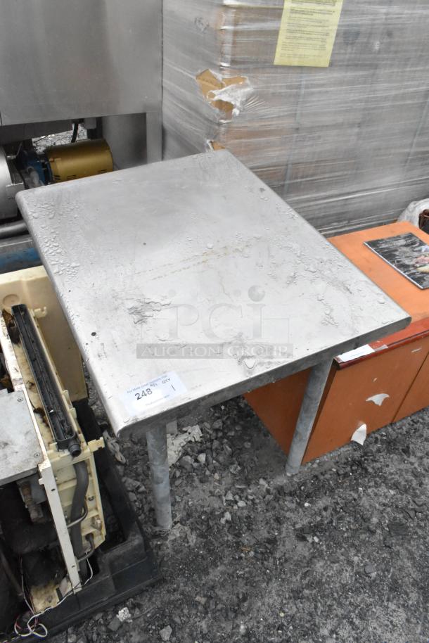 Stainless steel table with visible wear, sturdy legs. Auction tag marked "248" indicates item number. Suitable for industrial use.