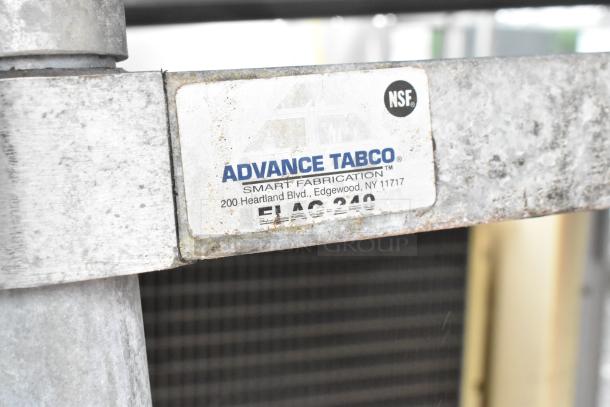 Advance Tabco stainless steel table, model ELAG-240, NSF certified, used condition with visible wear.
