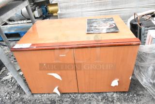 Wood Pattern 2 Door Cabinet, signs of wear, peeling stickers, label "250". Suitable for restoration or storage.