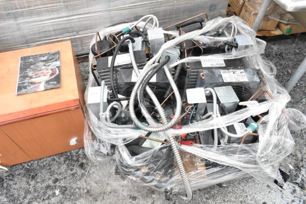 Four commercial compressors including Copeland M4FHC050-CAV-045 and M6CMC0038-IAV-040, wrapped in plastic with visible labels.