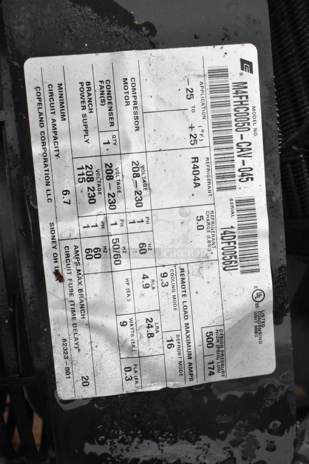 Label on Copeland compressor model M4FHC050-CAV-045, showing specs: 208-230V, R404A refrigerant, 5 HP, 60Hz, manufactured by Copeland Corporation.
