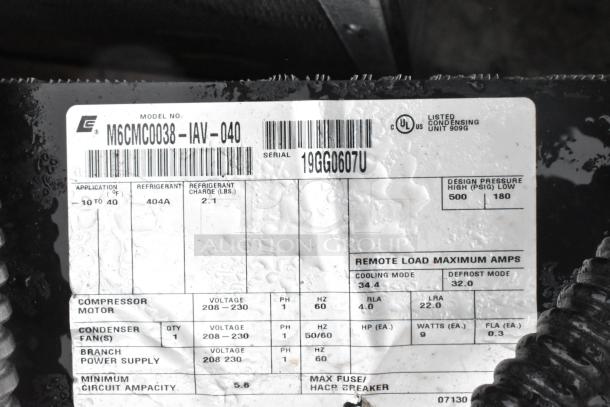 Close-up of label on Copeland M6CMC0038-IAV-040 compressor, detailing voltage, refrigerant, and pressure specifications.