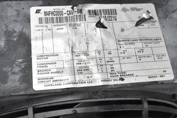 Image of a Copeland M4FHC050-CAV-045 compressor label showing model specs, power supply, and application details. Used condition.