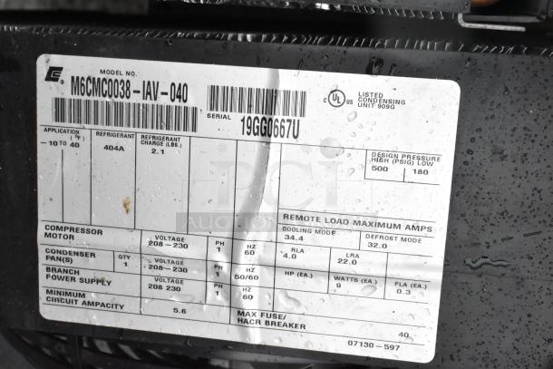 Close-up of Copeland compressor model M6CMC0038-IAV-040 label, showing specifications, refrigerant type, and voltage details.