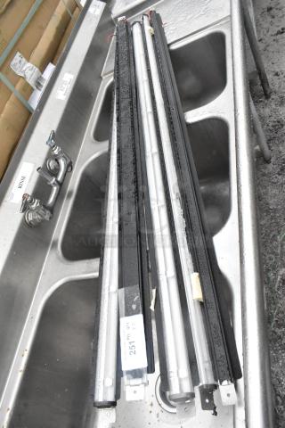 Five industrial light fixtures with black housings, positioned in a stainless steel sink. Marked "251 5x Qty."