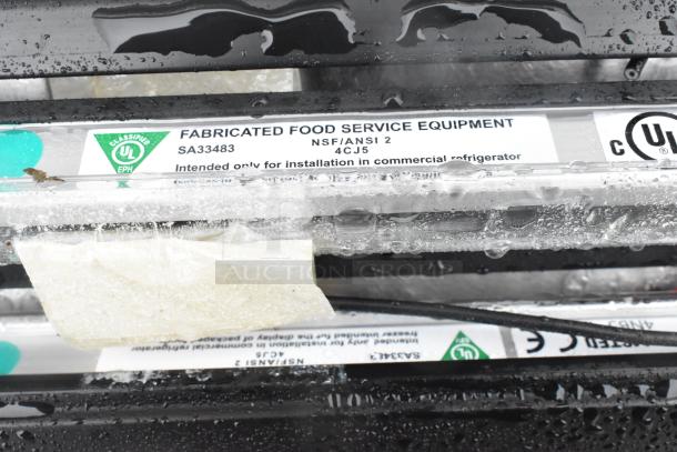 Fabricated food service equipment with NSF/ANSI 2 certification label, intended for commercial refrigerators, model SA33483.