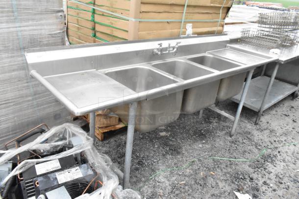 Stainless steel 3 bay sink with dual drain boards and handles, used condition, includes faucet, ideal for commercial use.