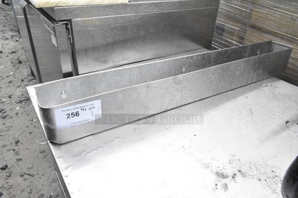Stainless Steel Speewell with visible auction tag, slightly wet surface, rectangular shape, sturdy condition.