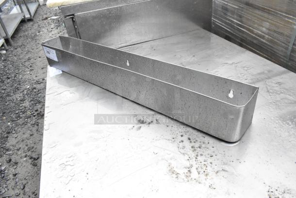 Stainless Steel Speewell, durable and rust-resistant, showing slight use marks. Background includes surroundings of a warehouse.