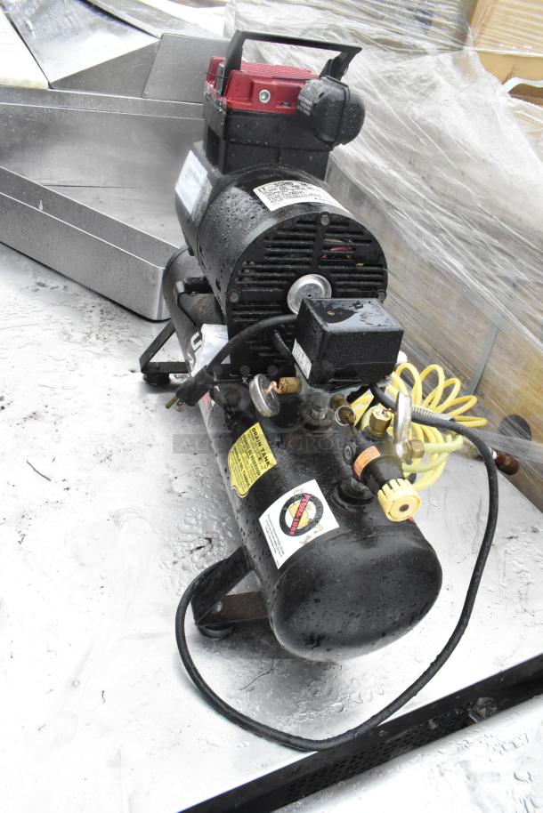 Thomas T-35HD M Ultra Air Pac Air Compressor, 115V, used condition. Visible labels with safety warnings and specs.