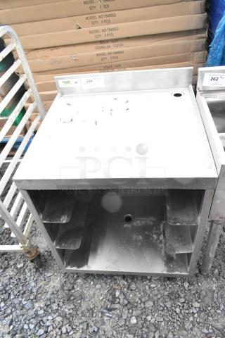 Regency 600GRSU2324C stainless steel drain board, slightly worn, features a flat surface with ridges, includes labels and shelving.