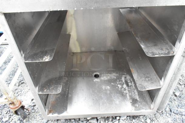 Regency 600GRSU2324C Stainless Steel Drain Board, featuring four sloped shelves. Visible wear indicates used condition.