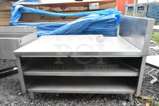 Stainless steel equipment stand with two under shelves, durable, good condition, suitable for kitchen or industrial use.