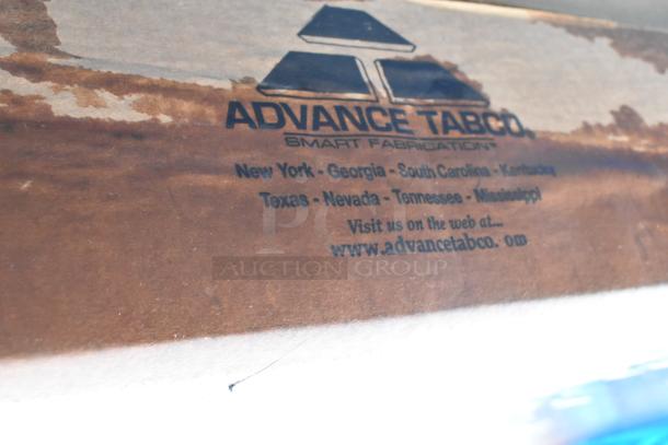 Alt text: Box with Advance Tabco branding, listing locations and website for TMS-306 work table.