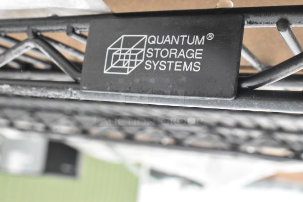 19 boxes of Quantum Storage 2448BK black wire shelves, scratch and dent condition; quantum logo visible.