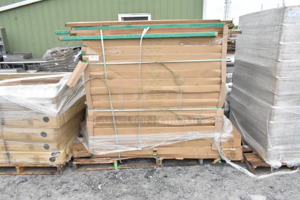 Stacked boxes of Quantum Storage 2460P wire shelves and P63P poles on pallets, brand new, labeled and secured with straps.