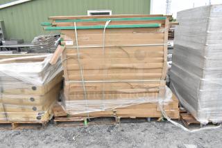 Stacked boxes of Quantum Storage 2460P wire shelves and P63P poles on pallets, brand new, labeled and secured with straps.