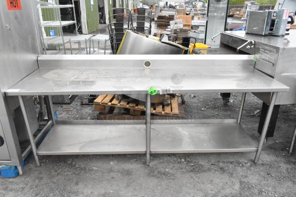 Stainless steel table with under shelf and back splash, used. Price tag visible: $25.00. Good condition, ideal for kitchens.