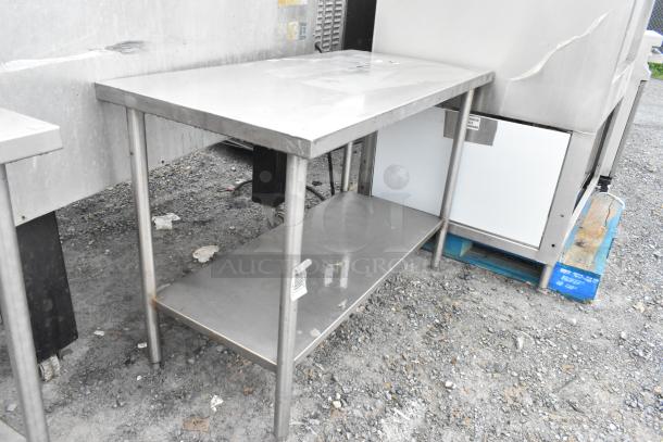 Stainless steel table with under shelf, rectangular, used condition, with bar code tag. Suitable for kitchen use.