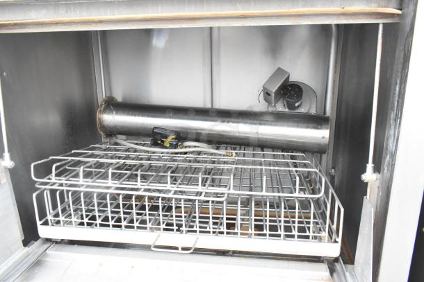 Douglas DSI SD-20-ELEL stainless steel front load pot and pan washer, interior view showing racks and components.