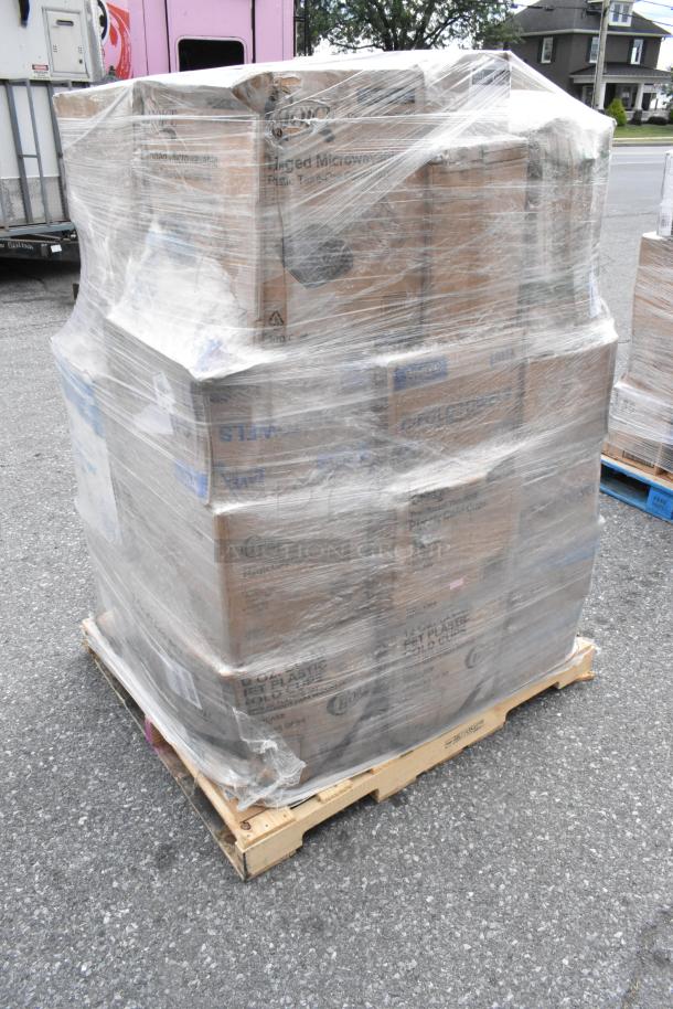 Shrink-wrapped pallet of assorted scratch and dent items, including towels, bakery boxes, cups, and napkins. Boxes labeled "Wells."