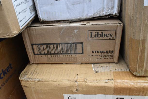 Cardboard boxes labeled "Libbey Stemless Wine Glasses" and "Mop Bucket" visible, indicating mixed item lot. Boxes show wear.
