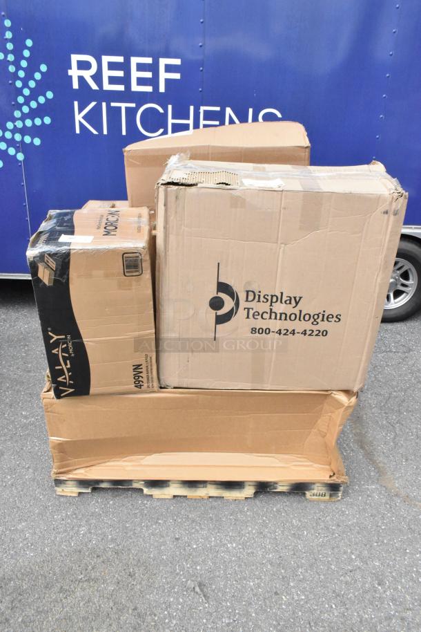 Cardboard boxes on pallet, labeled "Display Technologies" and "VALAY by MORCON." New, scratch, and dent items including organizer.