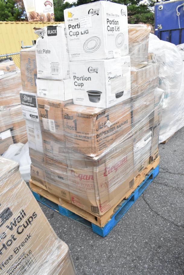 Pallet of new, scratch and dent items including towel rolls, paper plates, cold cups, trash bags, and food trays, wrapped.